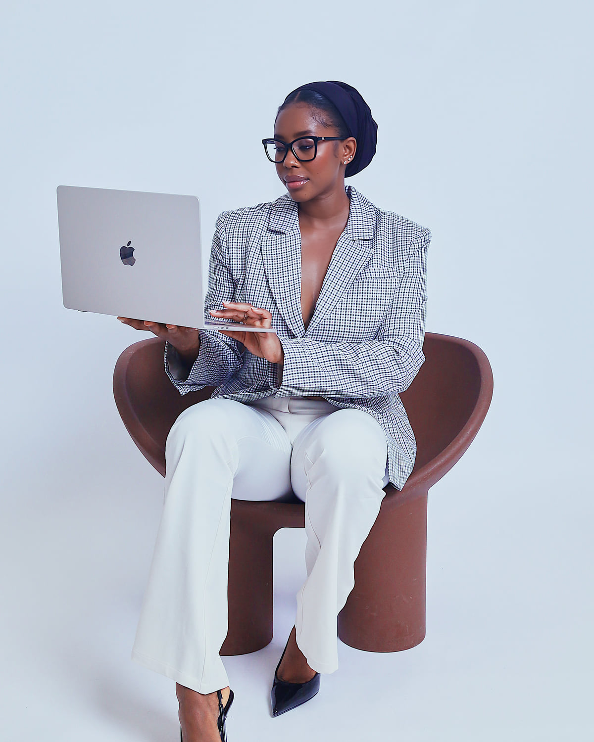 Sohna Oulare seated and working on a laptop