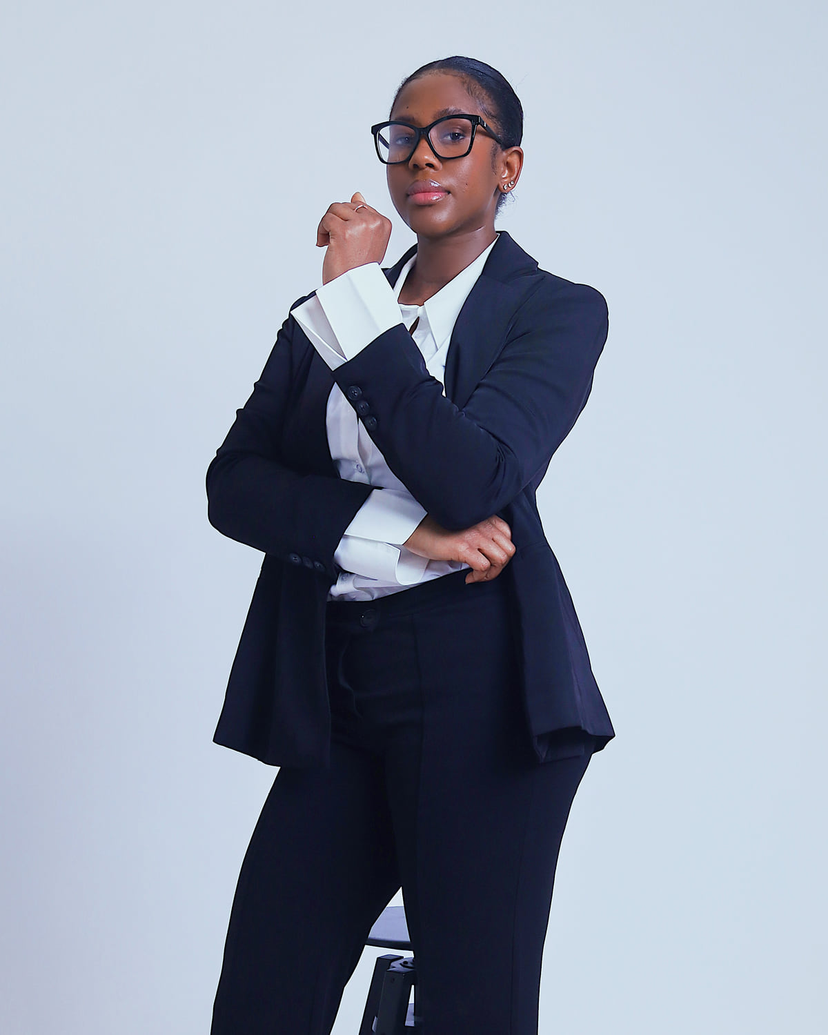 Standing portrait of Sohna Oulare in a navy suit